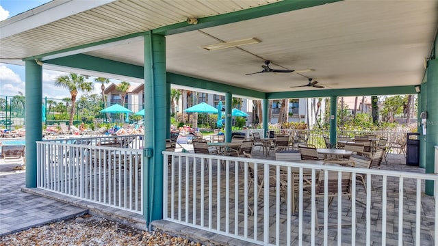 view of patio with ceiling fan and fence