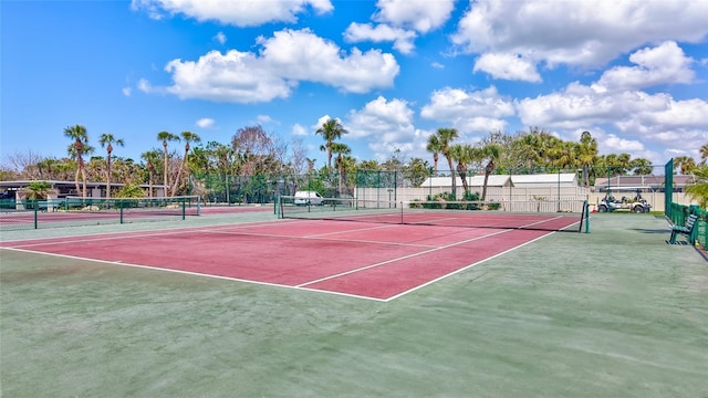 view of tennis court with fence and community basketball court