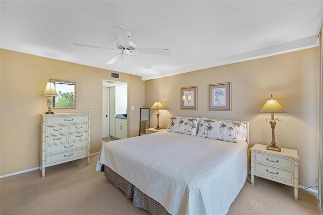 carpeted bedroom featuring visible vents, a ceiling fan, baseboards, and connected bathroom