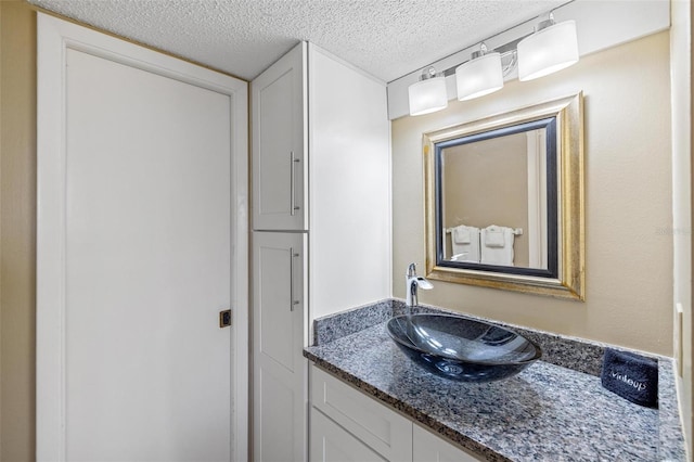 bathroom with vanity and a textured ceiling