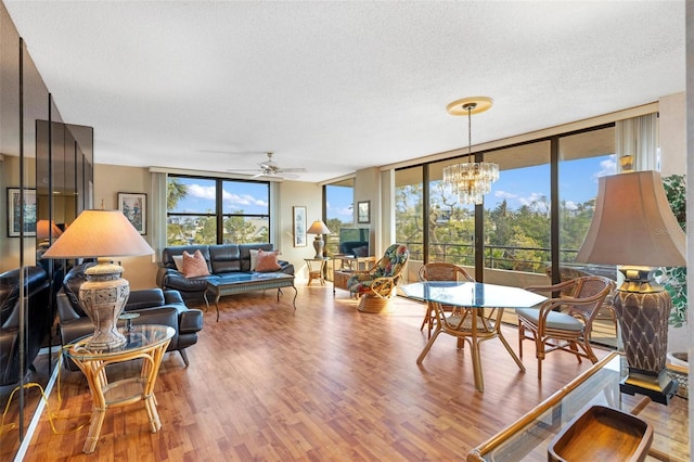 6415 Midnight Pass Rd Unit 204, Sarasota, FL 34242 - living room with a textured ceiling, wood finished floors, a ceiling fan, a chandelier, and a wall of windows