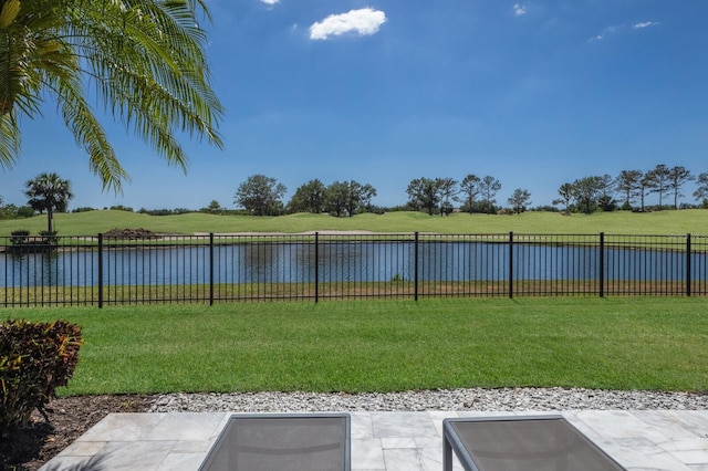 view of yard featuring fence and a water view