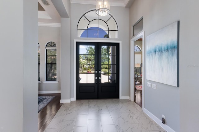 foyer featuring french doors, crown molding, visible vents, baseboards, and marble finish floor