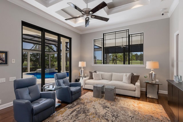 living area featuring a wealth of natural light, dark wood-style flooring, and a ceiling fan