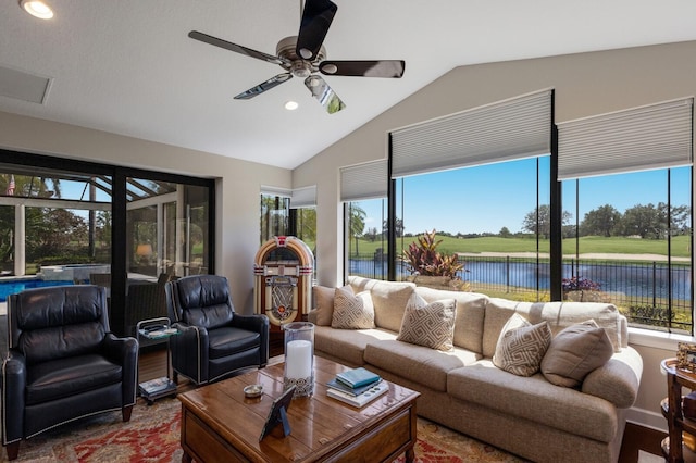 living room featuring vaulted ceiling, ceiling fan, and recessed lighting