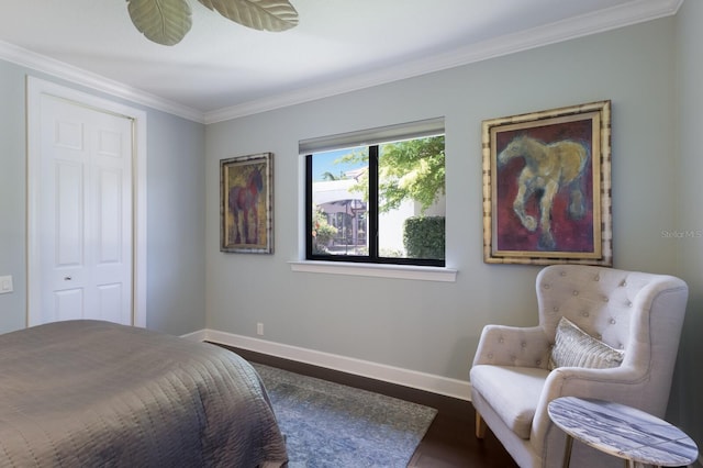 bedroom with wood finished floors, baseboards, and ornamental molding