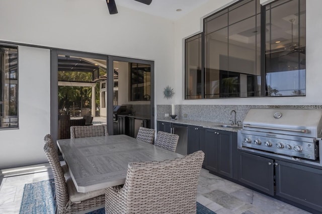 view of patio / terrace featuring outdoor dining space, a sink, exterior kitchen, ceiling fan, and grilling area