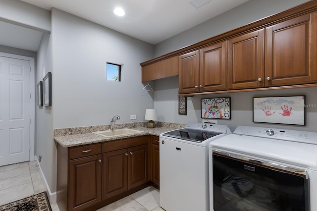 laundry room with washer and dryer, light tile patterned flooring, a sink, visible vents, and cabinet space
