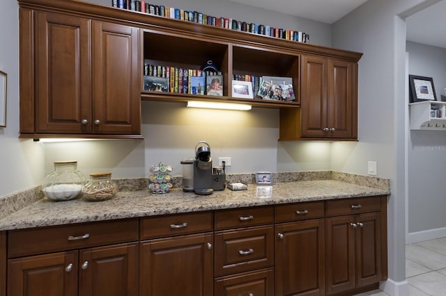 kitchen featuring light stone countertops, open shelves, and light tile patterned floors