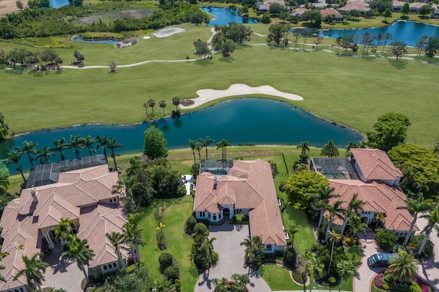 aerial view with view of golf course, a water view, and a residential view