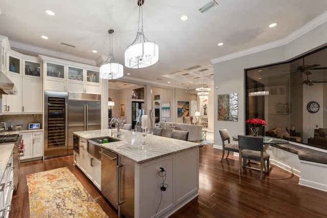 kitchen with beverage cooler, open floor plan, visible vents, and a sink