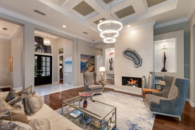 living room featuring crown molding, visible vents, coffered ceiling, and wood finished floors