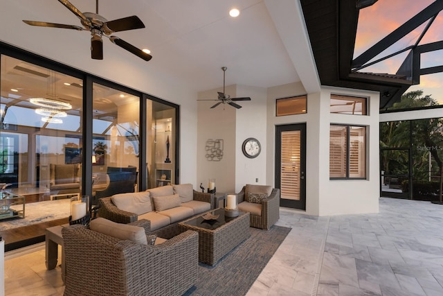 view of patio / terrace featuring a ceiling fan, glass enclosure, and an outdoor living space