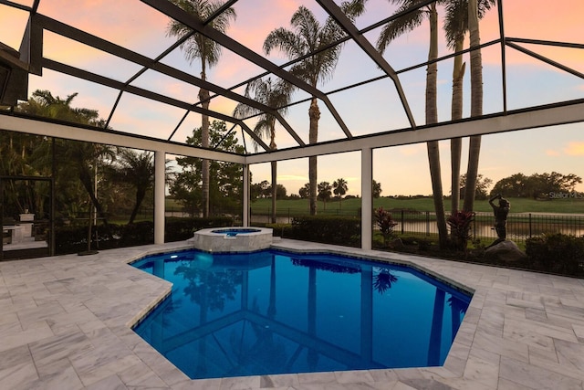 view of pool featuring a pool with connected hot tub, a lanai, and a patio