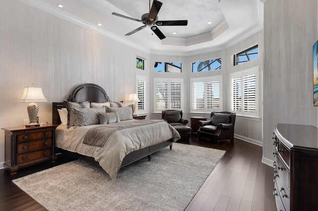 bedroom featuring crown molding, dark wood finished floors, baseboards, a raised ceiling, and ceiling fan