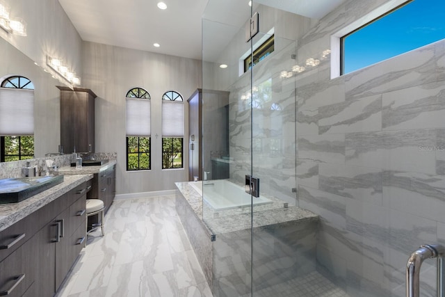 bathroom featuring vanity, a wealth of natural light, marble finish floor, and a stall shower