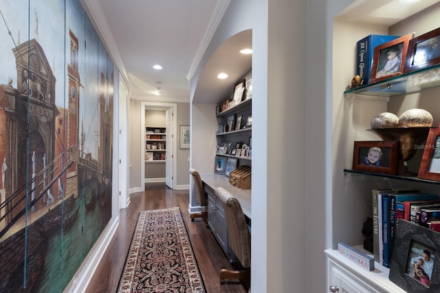 corridor featuring recessed lighting, baseboards, ornamental molding, built in features, and dark wood-type flooring