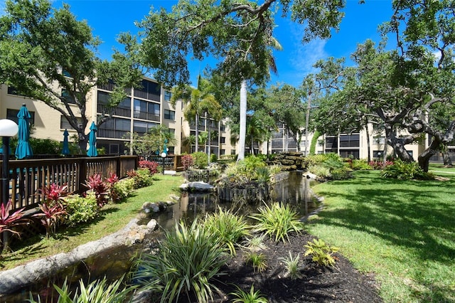 625 30th Ave W Unit G210, Bradenton, FL 34205 - view of community with a lawn and a small pond
