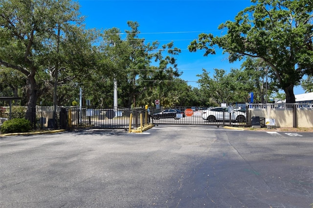 625 30th Ave W Unit G210, Bradenton, FL 34205 - view of asphalt road featuring traffic signs, a gate, and a gated entry