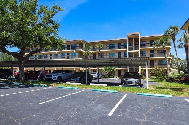 625 30th Ave W Unit G210, Bradenton, FL 34205 - view of property with covered and uncovered parking