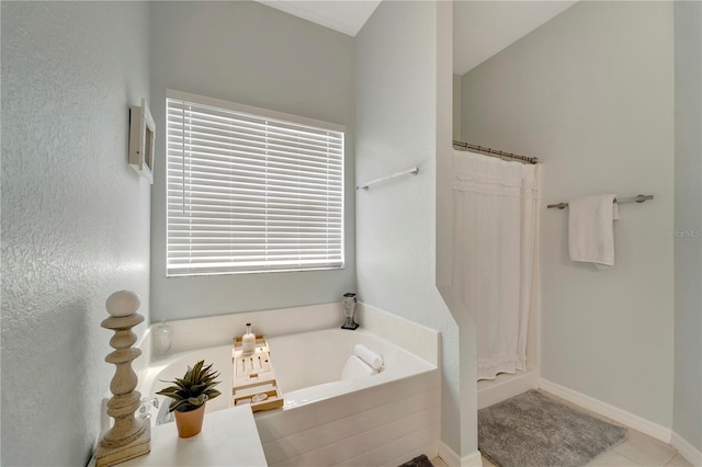 bathroom featuring a bath, tile patterned flooring, and curtained shower