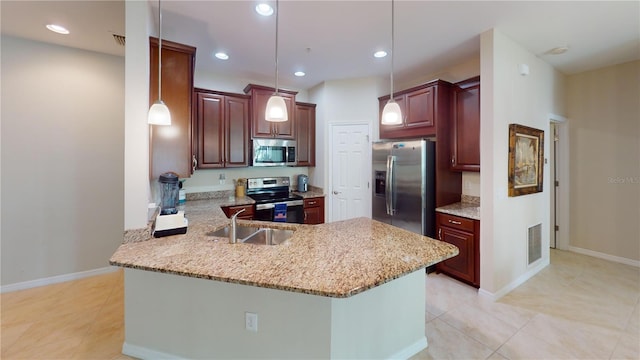 116 Navigation Cir Unit 106, Osprey, FL 34229 - kitchen with appliances with stainless steel finishes, a sink, a peninsula, hanging light fixtures, and light tile patterned floors