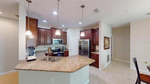 116 Navigation Cir Unit 106, Osprey, FL 34229 - kitchen with appliances with stainless steel finishes, a peninsula, a sink, hanging light fixtures, and light stone counters