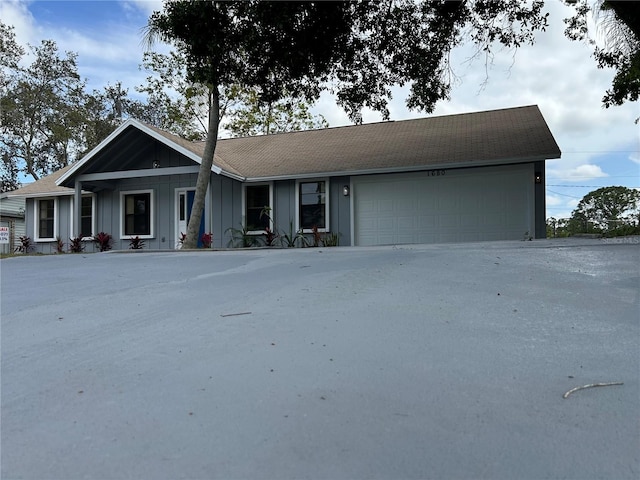 ranch-style house with board and batten siding and a garage