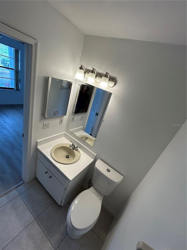 bathroom with toilet, tile patterned floors, and vanity