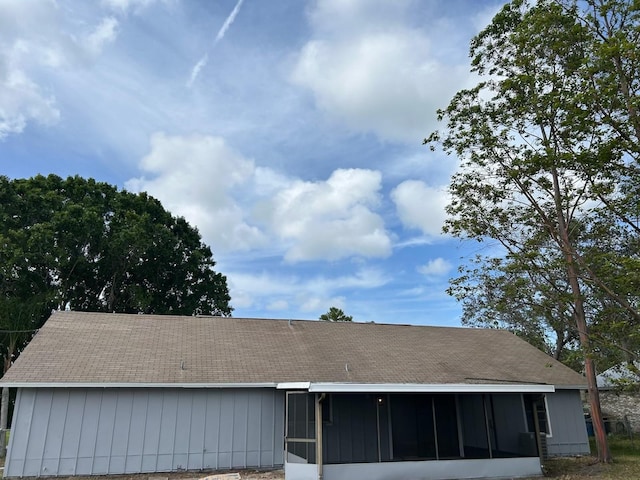 exterior details with roof with shingles