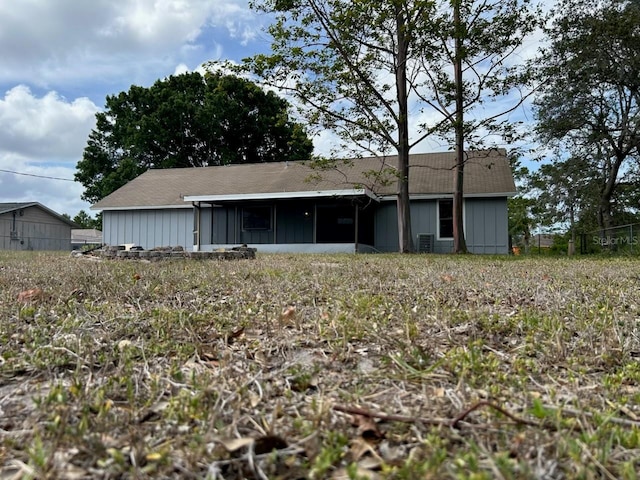 rear view of property with board and batten siding