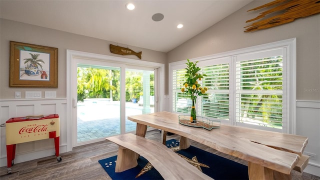 dining room with wood finished floors, recessed lighting, and lofted ceiling