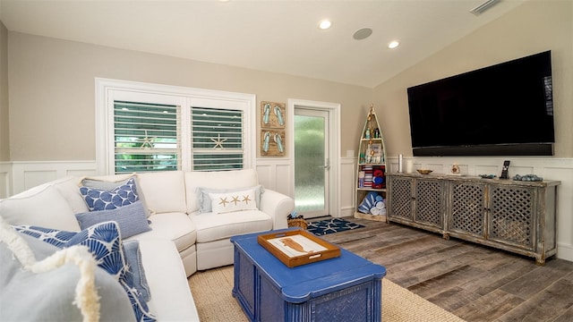 living room featuring a wainscoted wall, wood finished floors, and visible vents