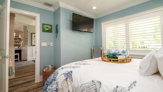 bedroom with visible vents, ornamental molding, wood finished floors, and recessed lighting