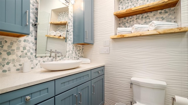 half bath featuring vanity, toilet, and tasteful backsplash