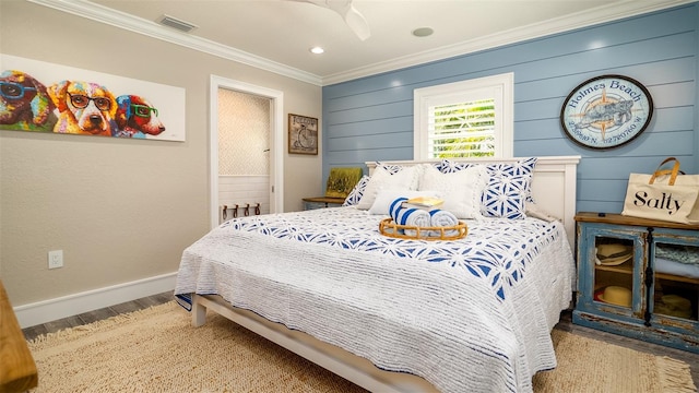 bedroom with visible vents, wood finished floors, baseboards, ornamental molding, and recessed lighting