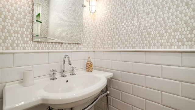 bathroom featuring wainscoting and wallpapered walls
