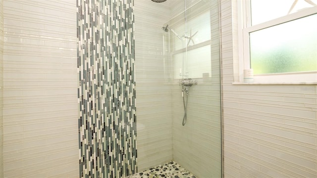 bathroom with a tile shower