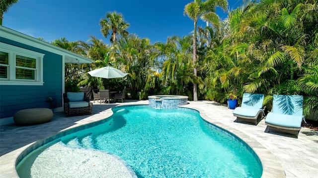 view of pool with outdoor dining space, a pool with connected hot tub, and a patio area
