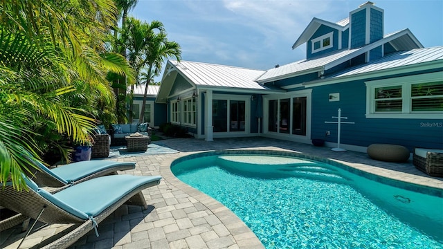 pool featuring a patio and an outdoor living space