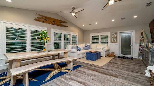 living room featuring wainscoting, wood finished floors, ceiling fan, recessed lighting, and vaulted ceiling