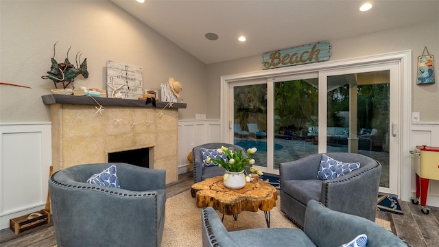living room with recessed lighting, wainscoting, a decorative wall, and wood finished floors