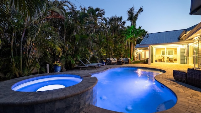 pool featuring a patio, an in ground hot tub, and outdoor lounge area