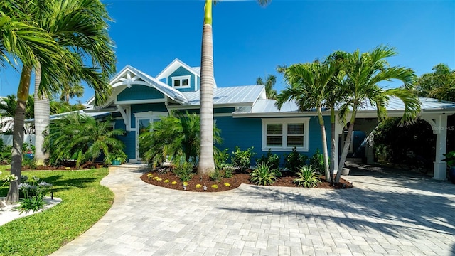 view of front of property featuring metal roof and decorative driveway