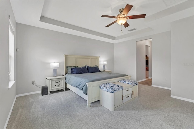 7418 61st St E, Palmetto, FL 34221 - bedroom featuring baseboards, visible vents, light carpet, and a raised ceiling