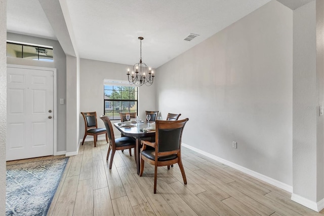 7418 61st St E, Palmetto, FL 34221 - dining area with light wood-style floors, baseboards, a notable chandelier, and visible vents