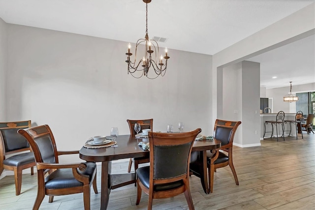 7418 61st St E, Palmetto, FL 34221 - dining area featuring baseboards, wood finished floors, a chandelier, and visible vents