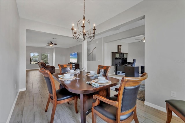 7418 61st St E, Palmetto, FL 34221 - dining area with baseboards, ceiling fan with notable chandelier, and light wood-type flooring