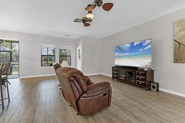 7418 61st St E, Palmetto, FL 34221 - living room with baseboards, ceiling fan, plenty of natural light, and wood finished floors