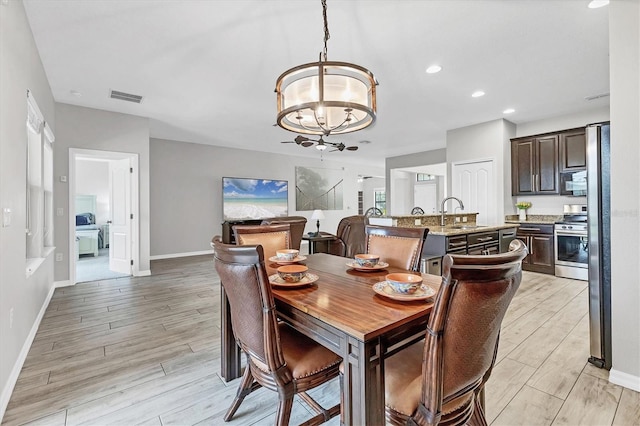7418 61st St E, Palmetto, FL 34221 - dining space featuring visible vents, baseboards, recessed lighting, light wood-style flooring, and a notable chandelier